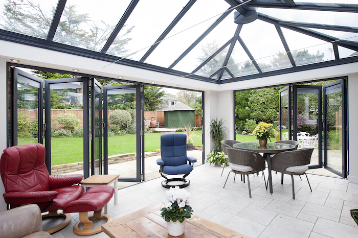 With open bi-folding doors the landscaped garden is merged into the room giving an uninterrupted view